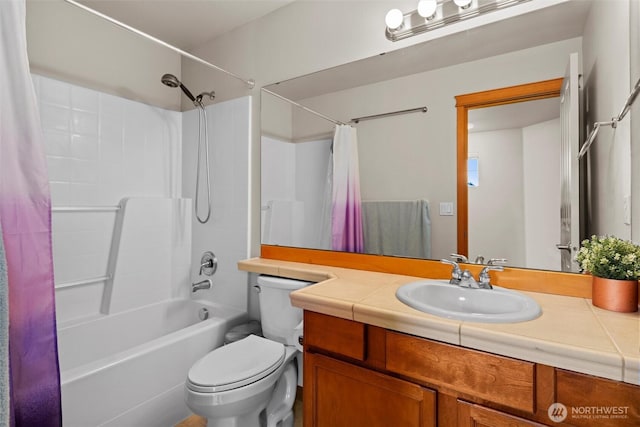 full bath with toilet, vanity, and shower / bath combo