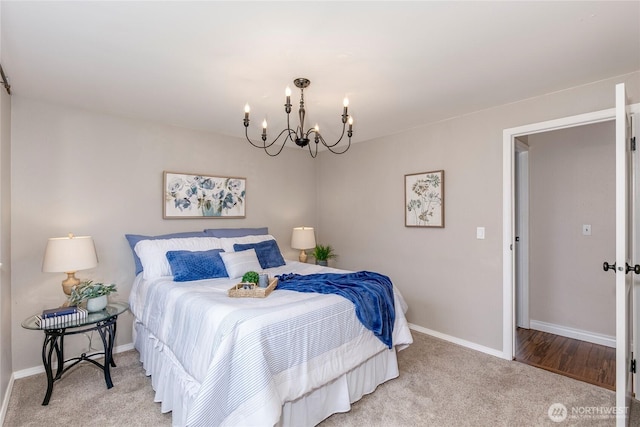 carpeted bedroom featuring an inviting chandelier