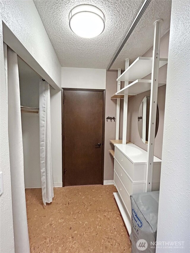 mudroom with a textured ceiling