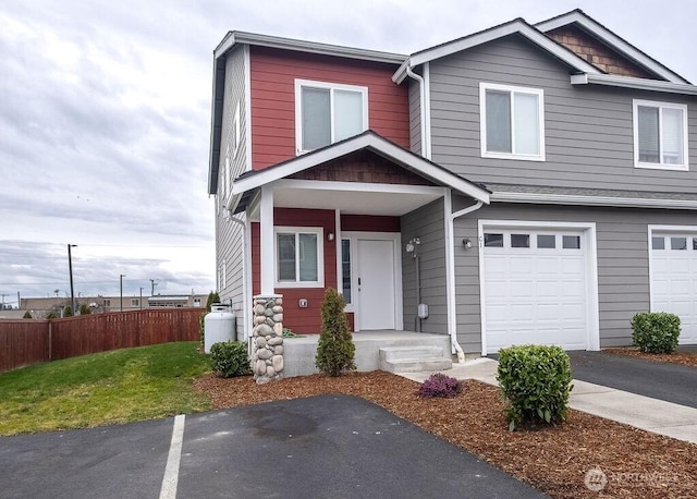 view of front of property with a garage and fence