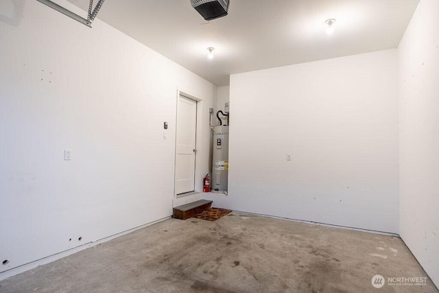 garage featuring strapped water heater and a garage door opener