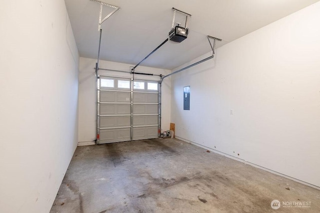 garage featuring electric panel and a garage door opener