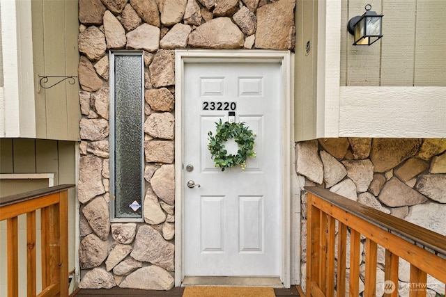 entrance to property featuring stone siding