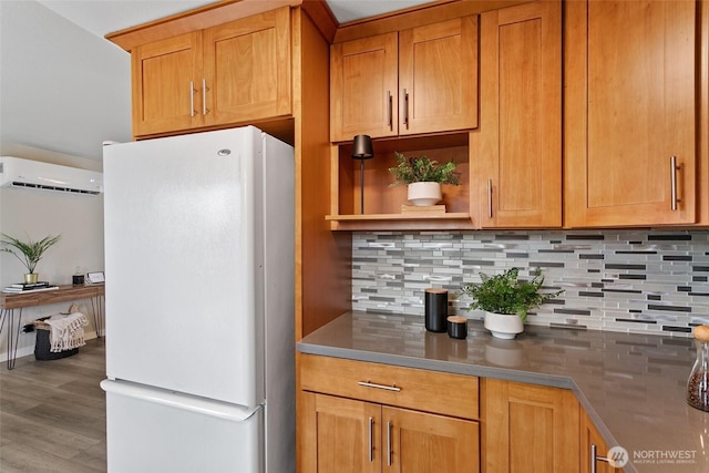 kitchen featuring a wall mounted air conditioner, open shelves, backsplash, wood finished floors, and freestanding refrigerator