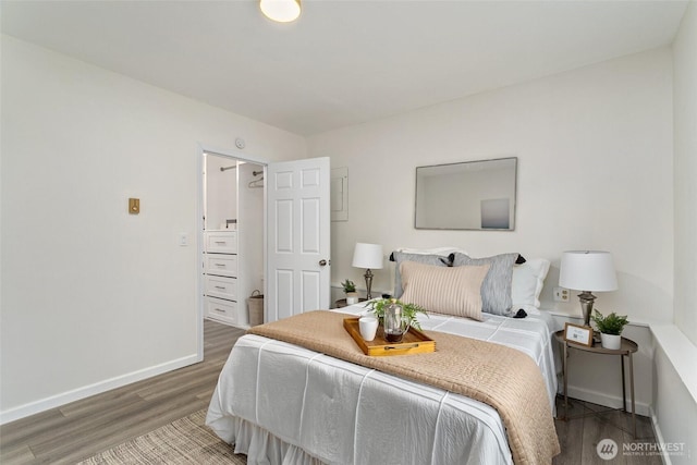 bedroom featuring wood finished floors and baseboards