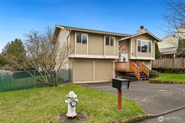 raised ranch with fence, aphalt driveway, a front yard, a chimney, and an attached garage