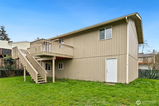 back of house with a lawn, stairs, and a deck