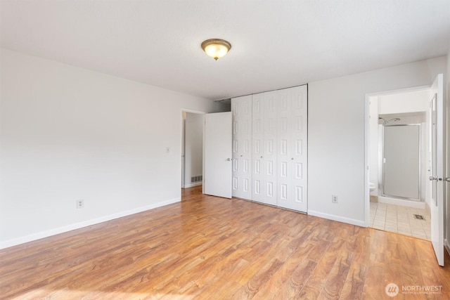 unfurnished bedroom with visible vents, baseboards, light wood-type flooring, and a closet