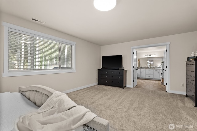 living area featuring light carpet, visible vents, and baseboards