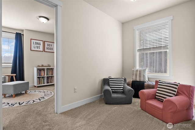 sitting room featuring carpet and baseboards