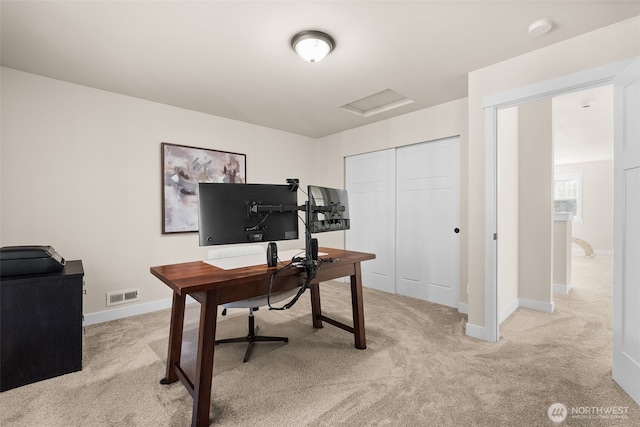 office area with light carpet, baseboards, visible vents, and attic access