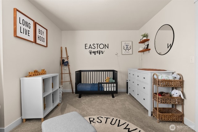 bedroom with light colored carpet, a crib, and baseboards