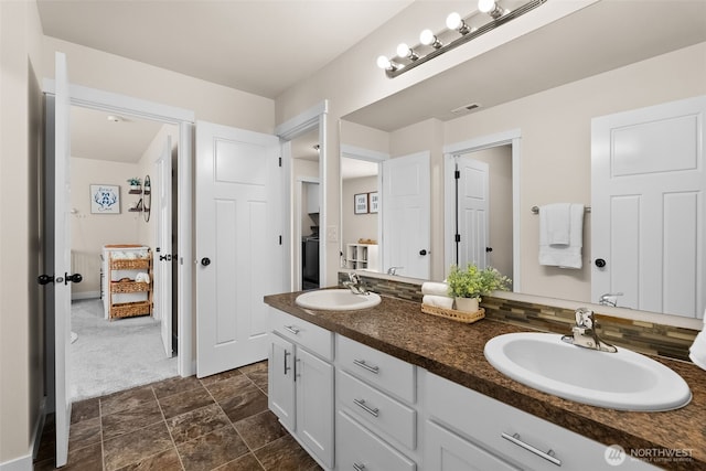 full bathroom with visible vents, a sink, and double vanity