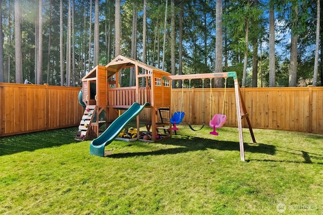 view of play area with a fenced backyard and a lawn