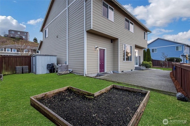 back of property featuring a patio, a fenced backyard, an outdoor structure, a lawn, and a shed