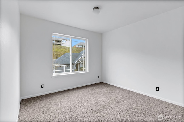 spare room with carpet flooring and baseboards