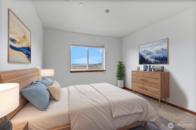 carpeted bedroom featuring baseboards