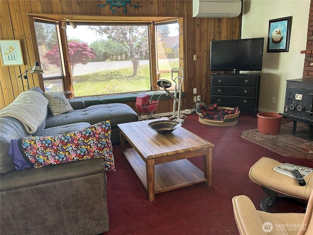 carpeted living area with a wall unit AC and wooden walls