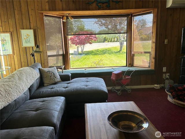 living room with wooden walls, a wall unit AC, and carpet flooring
