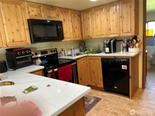 kitchen with black appliances and light countertops