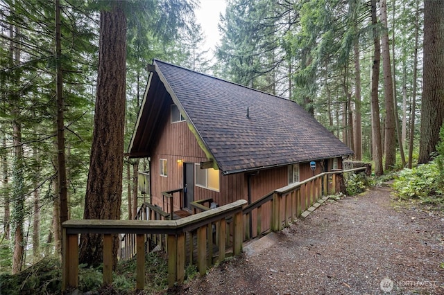 view of side of home featuring a shingled roof