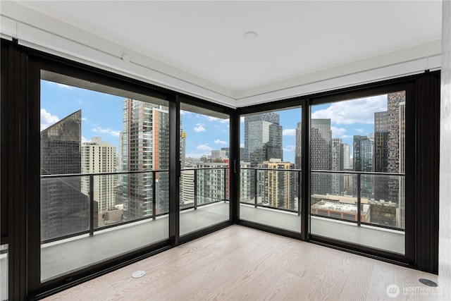 interior space featuring a view of city and wood finished floors