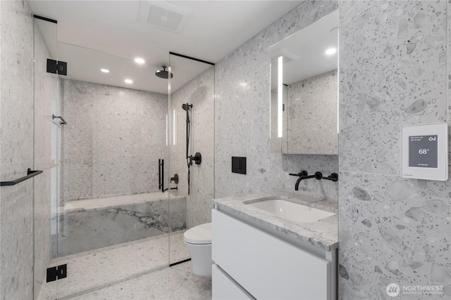 full bath featuring tile walls, recessed lighting, toilet, a stall shower, and vanity