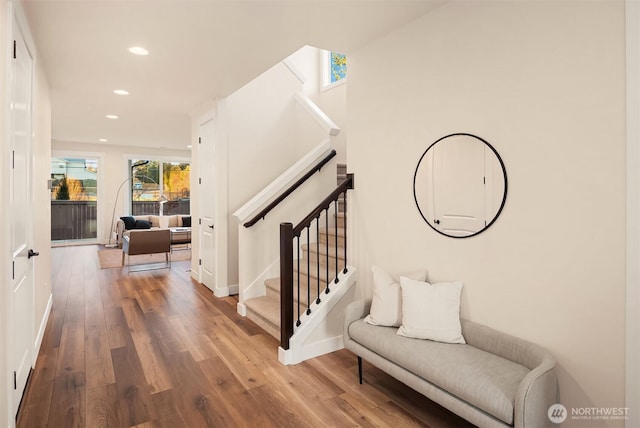 interior space with baseboards, wood finished floors, and recessed lighting