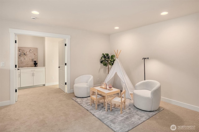 sitting room with light carpet, baseboards, and recessed lighting