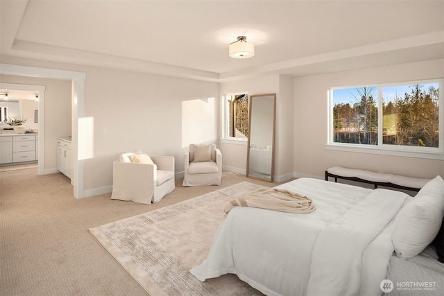 bedroom with baseboards, a tray ceiling, multiple windows, and light colored carpet