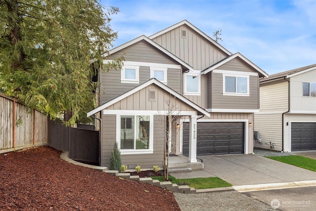 view of front of property with a garage, driveway, board and batten siding, and fence