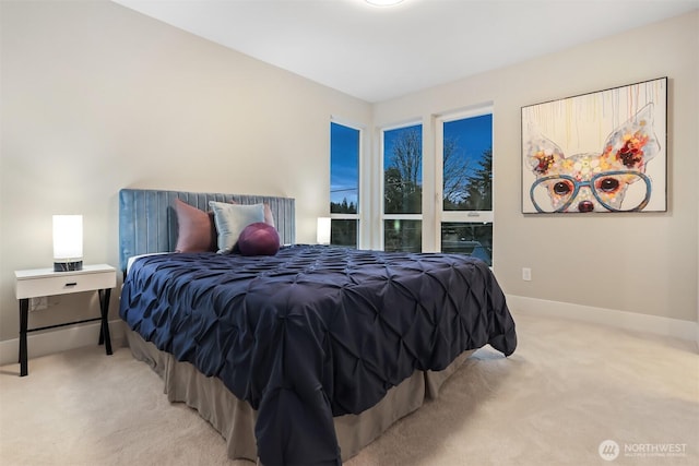 carpeted bedroom featuring baseboards