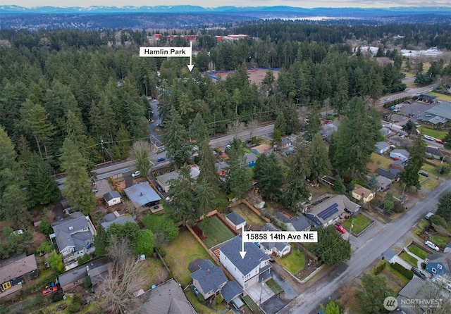 bird's eye view with a wooded view and a residential view