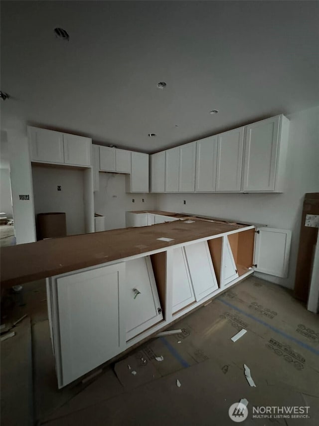 kitchen featuring white cabinets and wood finished floors