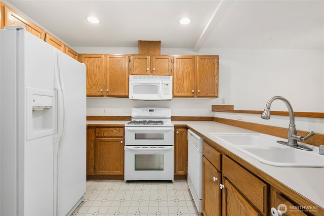 kitchen with white appliances, light countertops, light floors, a sink, and recessed lighting