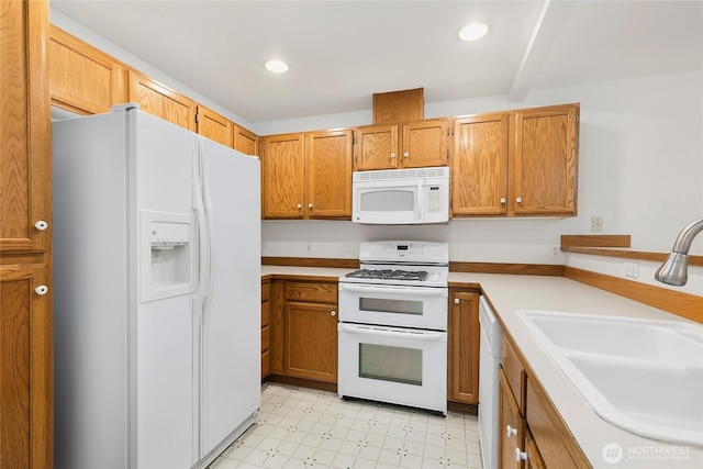 kitchen featuring white appliances, light countertops, light floors, a sink, and recessed lighting