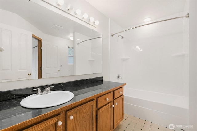 bathroom with shower / tub combination, vanity, and tile patterned floors