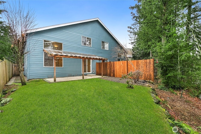 back of property featuring a patio, a lawn, and a fenced backyard