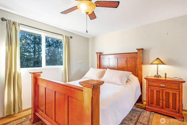 bedroom with light wood-type flooring and ceiling fan