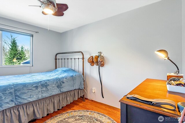 bedroom with wood finished floors and a ceiling fan