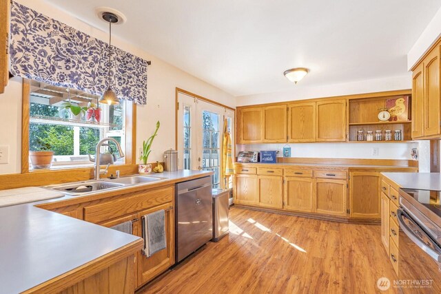 kitchen with brown cabinetry, appliances with stainless steel finishes, hanging light fixtures, open shelves, and a sink