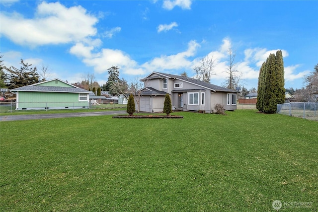 view of front of property with a garage, fence, aphalt driveway, and a front yard