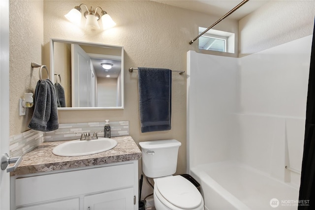 full bath with toilet, a textured wall, a shower, and vanity