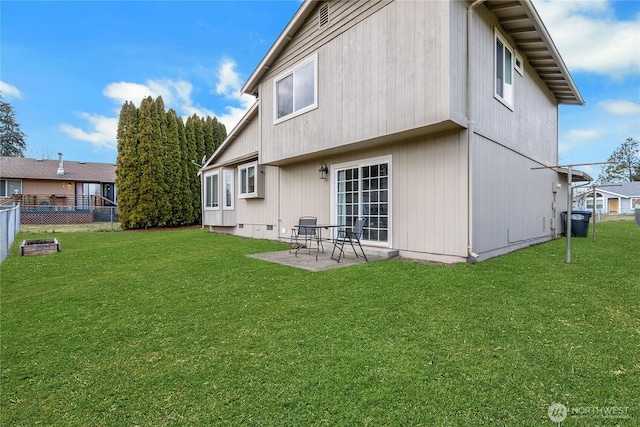 rear view of house featuring a patio area, fence, and a yard