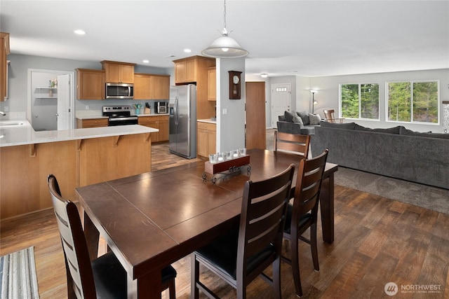 dining area with recessed lighting and wood finished floors