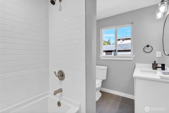 full bathroom with tile patterned floors, toilet, vanity, and tiled shower / bath combo