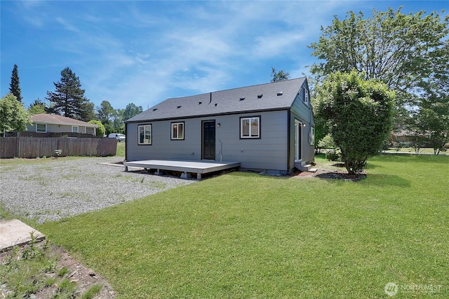 rear view of property with a lawn