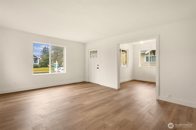 interior space featuring light wood-type flooring and baseboards