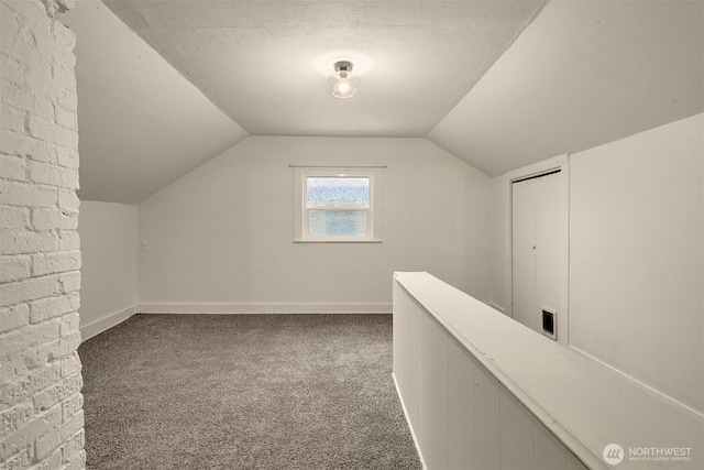 bonus room featuring baseboards, lofted ceiling, and carpet floors