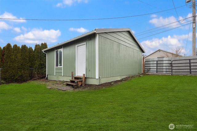 view of outbuilding with fence and entry steps